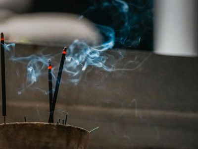 Incense stick burning in a peaceful room.